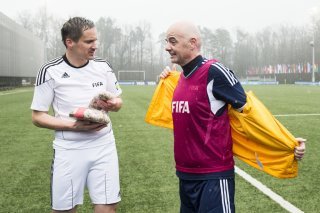 Swiss Gianni Infantino, new FIFA President, right, takes his jacket on next to Rinaldo Arnold, senior prosecutor for the Upper Valais, left, during a friendly football match at the Home of FIFA in Zurich, Switzerland, on Monday 29 February 2016. (KEYSTONE/Ennio Leanza)